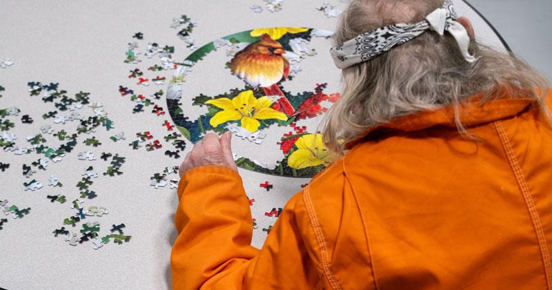 An inmate works on a puzzle at the Southern States Correctional Facility