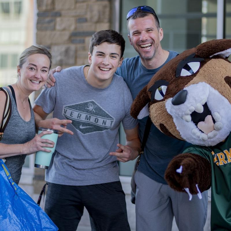 A family on move-in day with the UVM mascot