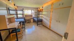 Residence hall room with two beds, two closets, and two desks. 