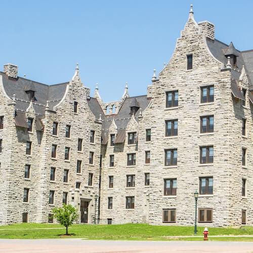A gothic-style, grey stone residence hall with five floors.