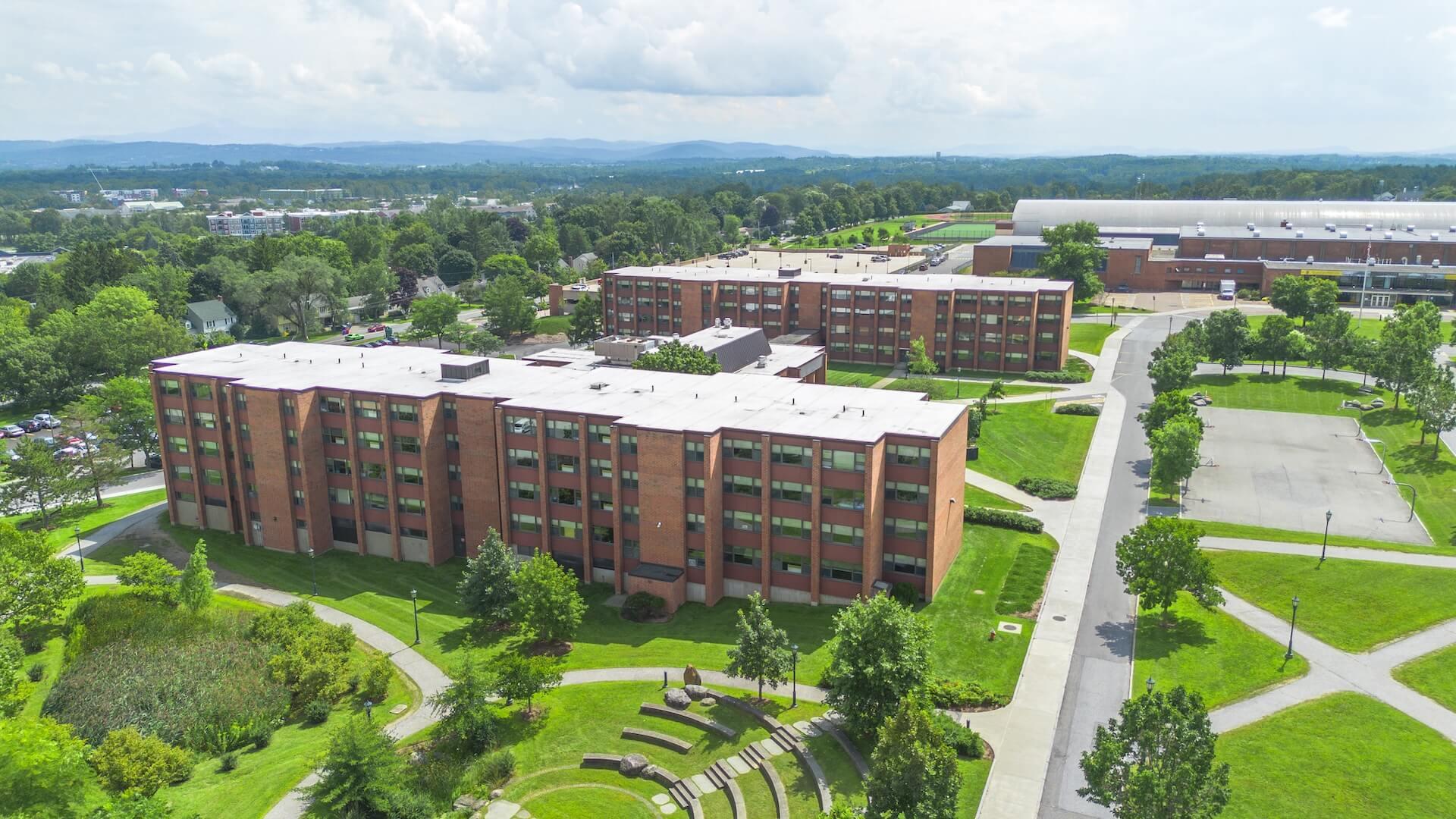 An aerial shot of a two-building residential hall complex surrounded by grassy common areas.