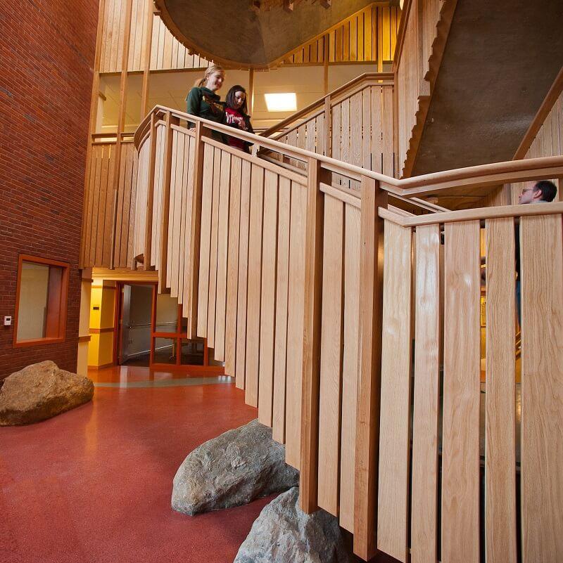A look up at the wooden staircase in the Aiken Center