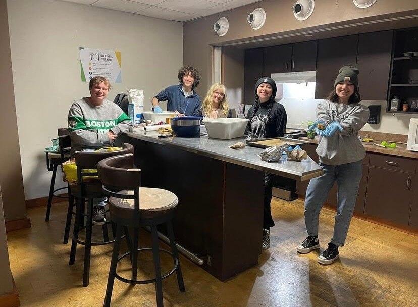 students in kitchen baking cookies
